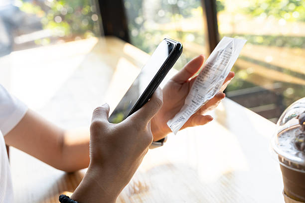 Small business owner scanning a receipt with smartphone